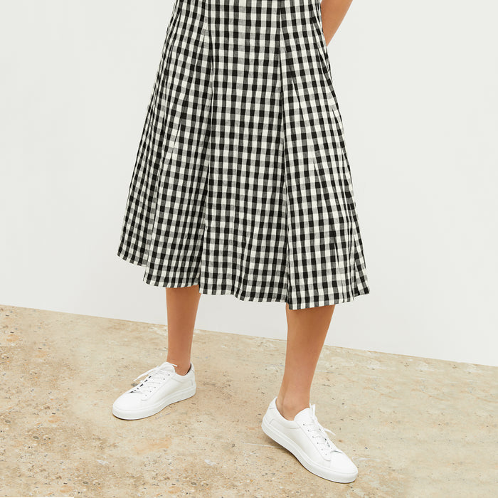 Front image of a woman wearing the nyla dress in black and white