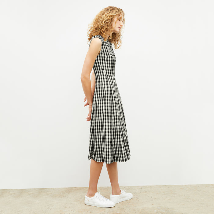 Front image of a woman wearing the nyla dress in black and white