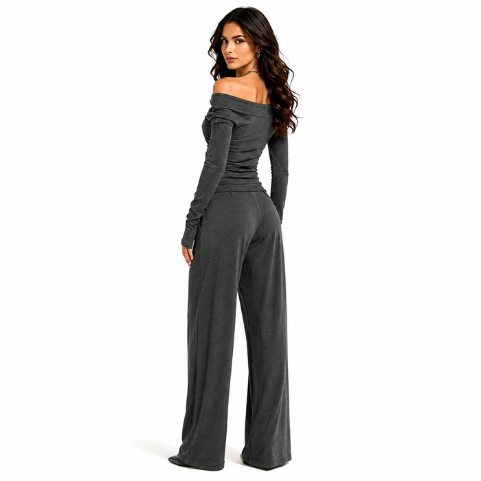 Women's charcoal off shoulder matching set shown from the back with long sleeve top and flowing wide leg pants on white.