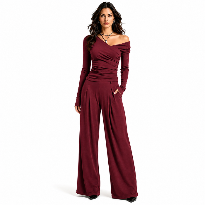 Women's wine red off shoulder wide leg pants set with ruched long sleeve top and coordinated full length trousers on white.