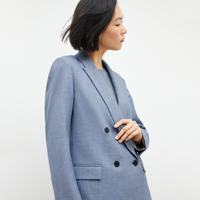 Front image of a woman wearing the ohara blazer in indigo and white