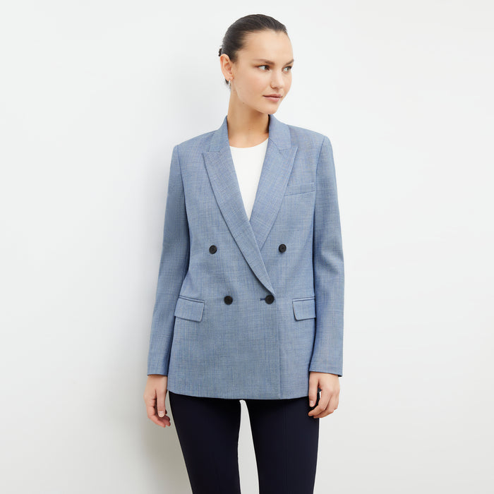 Front image of a woman wearing the ohara blazer in indigo and white