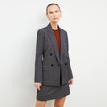 Front image of a woman wearing the ohara blazer in black and white | Lead