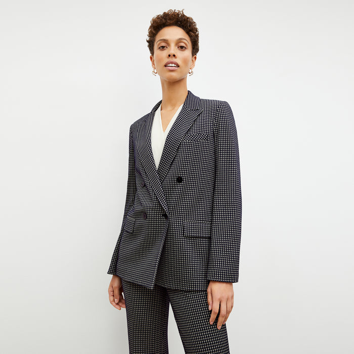Front image of a woman wearing the ohara blazer in black and white