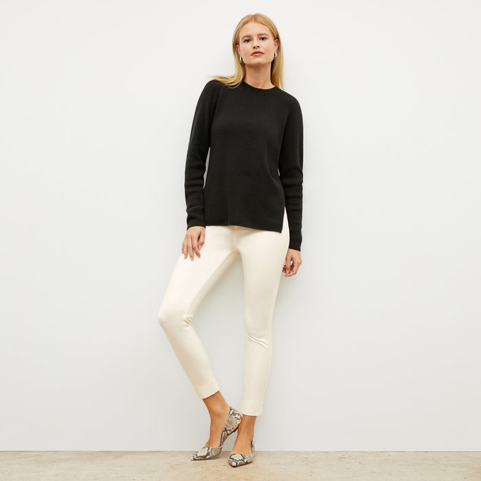 Front image of a woman wearing the ollie sweater in black | Lead