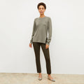 Front image of a woman wearing the ollie sweater in dark moss | Lead