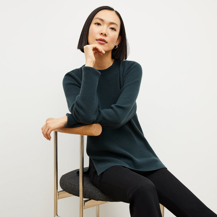 Front image of a woman wearing the ollie sweater in malachite | Lead