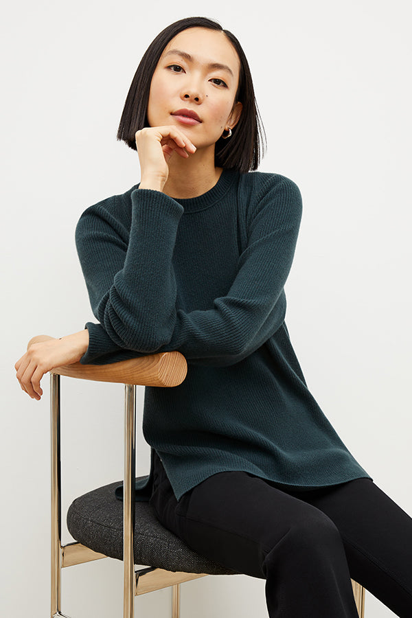 Front image of a woman wearing the ollie sweater in malachite | Exclude | Grid