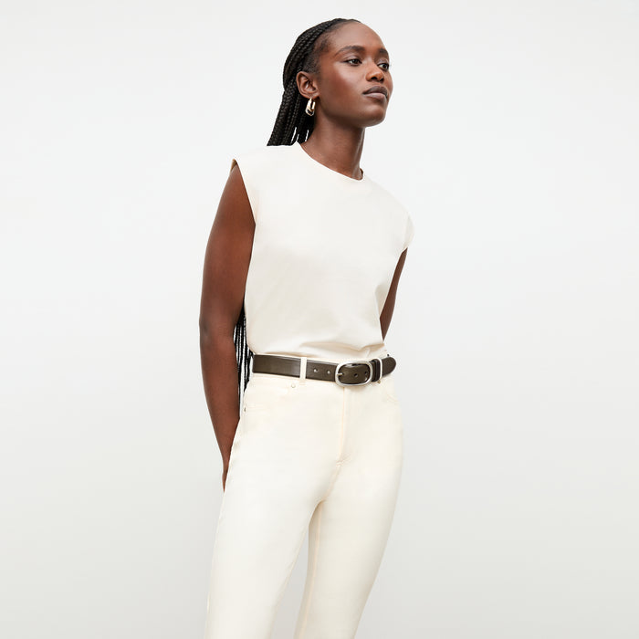 front image of a woman wearing the oval buckle belt in olive