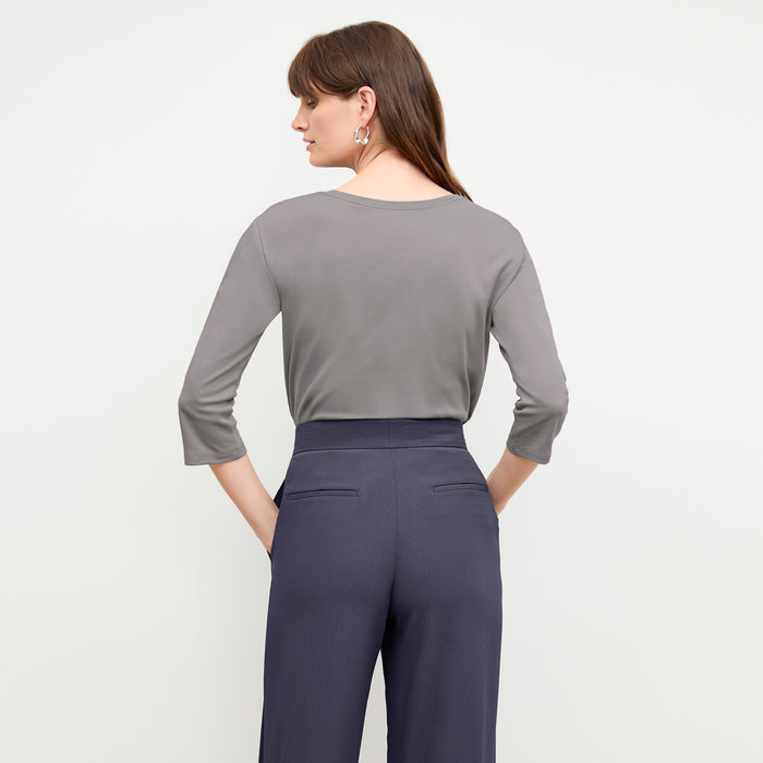 back image of a woman wearing the owen t-shirt in thistle