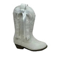 A single white faux-leather western boot with a white lace panel on the shaft, a white satin bow, and a dark brown stacked heel, shown against a plain white background.