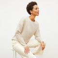 Front image of a woman wearing the para jardigan in ivory / champagne | Lead