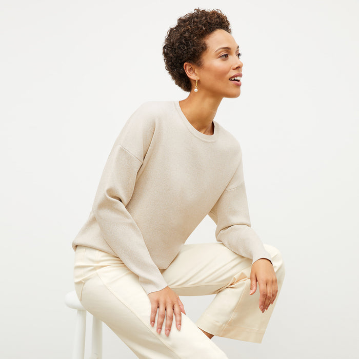 Front image of a woman wearing the para jardigan in ivory / champagne | Lead