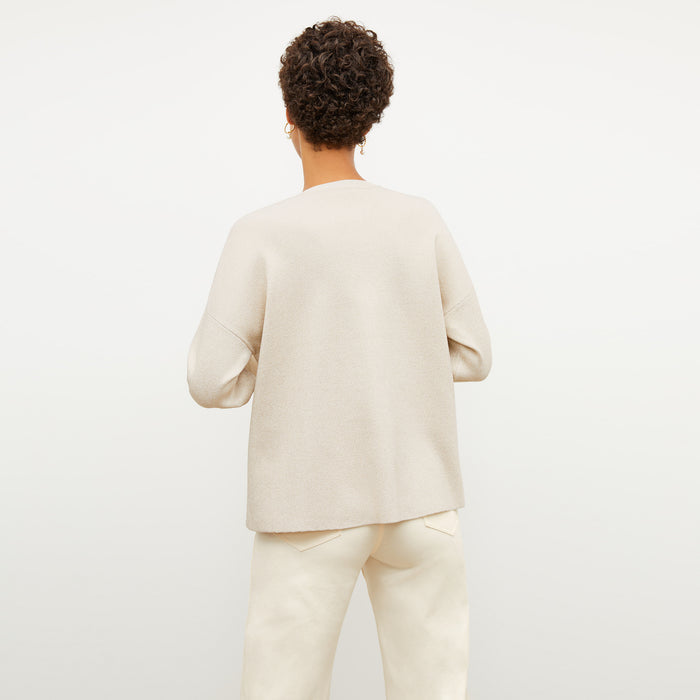 Back image of a woman wearing the para jardigan in ivory / champagne