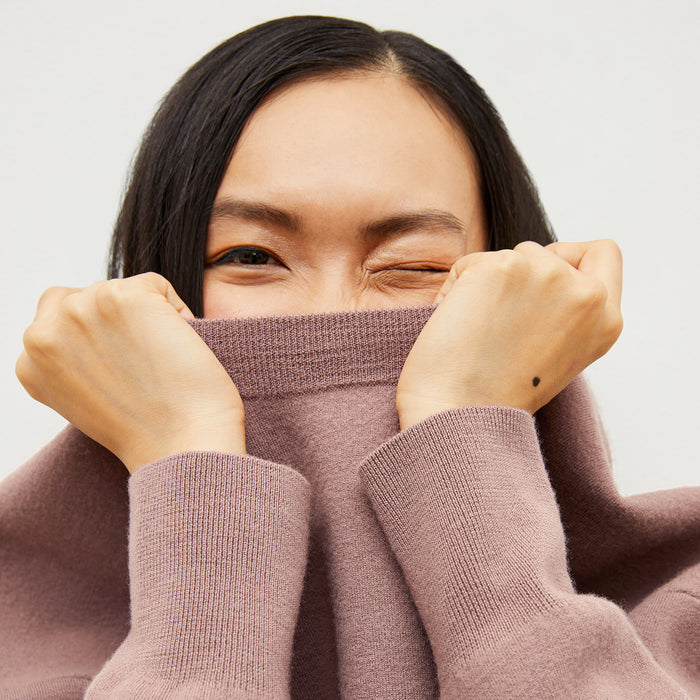 Front image of a woman wearing the quincy sweater in rose taupe
