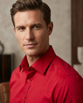 Man wearing a red shirt against a neutral background