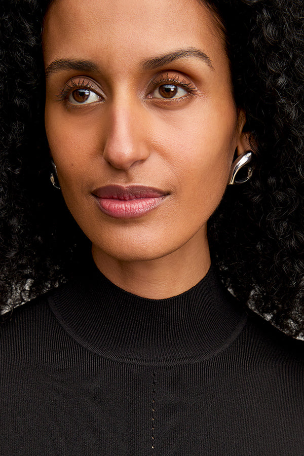 front image of a woman wearing the riya dress in black | Exclude
