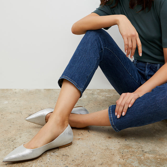 Woman sitting wearing the Rowan flat in Silver