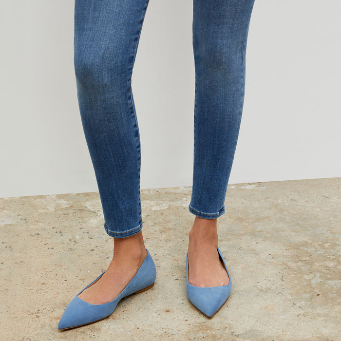Woman standing wearing the Rowan flat in Sky Blue