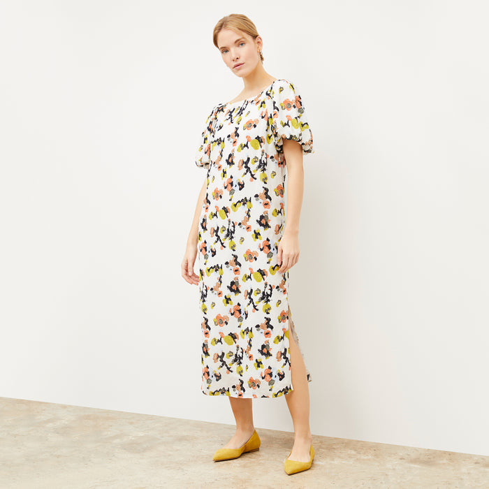 Front image of a woman wearing the Rowan flat in Turmeric