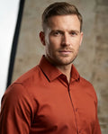 Man wearing a red shirt against a neutral background