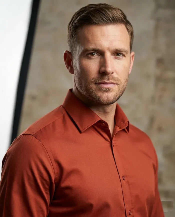 Man wearing a red shirt against a neutral background