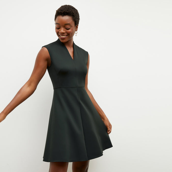 Front image of a woman wearing the ruth dress in forest