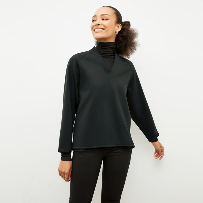 Front image of a woman wearing the shawn sweatshirt in forest | Lead