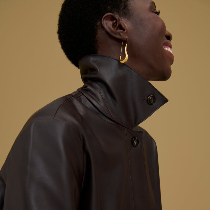 Front image of a woman wearing the Sima Earrings in Gold