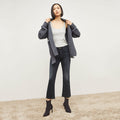 Front image of a woman standing wearing the FRAME Denim Le Crop Slim Bootcut Raw Edge Jean in Marcella | Lead