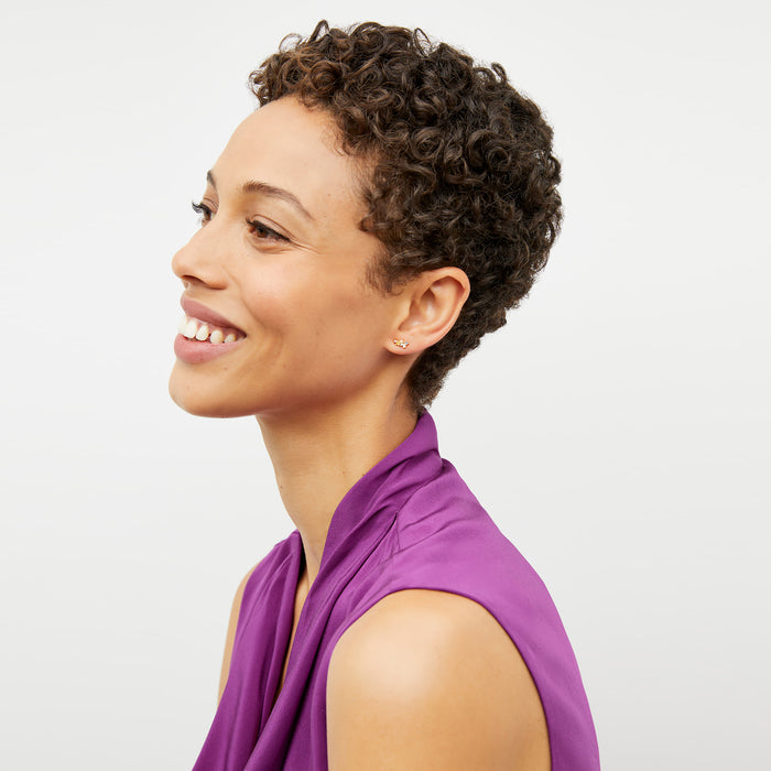 Detail image of a woman wearing the Sloane top in purple jasper