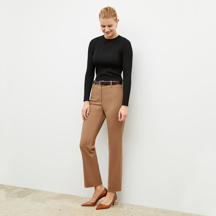 Front image of a woman wearing the smith in camel