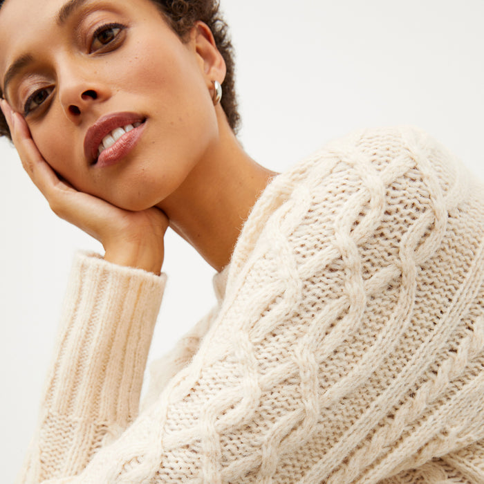 Image of a woman wearing the somers sweater in ivory