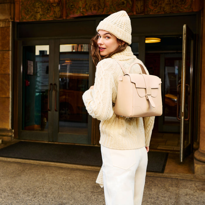 Image of a woman wearing the somers sweater in ivory