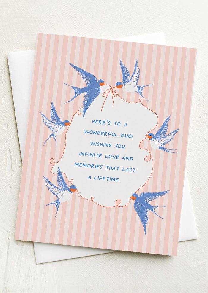 A greeting card with wedding-related text and illustrations of swallows.
