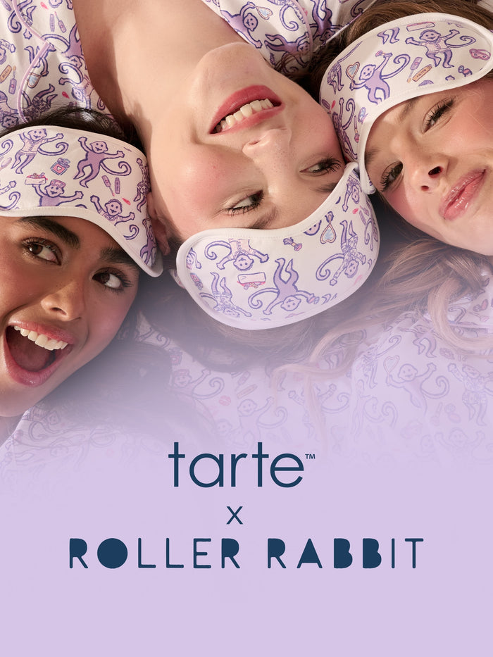 Three women lying down wearing matching white sleep masks, with the text 'tarte x ROLLER RABBIT' at the bottom on a lavender background.