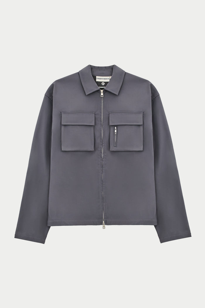 A long sleeve grey shirt with collar, chest cargo pockets, and a central zip fastening.