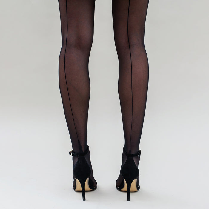 Image of a woman wearing the threads tights in sheer backseam black