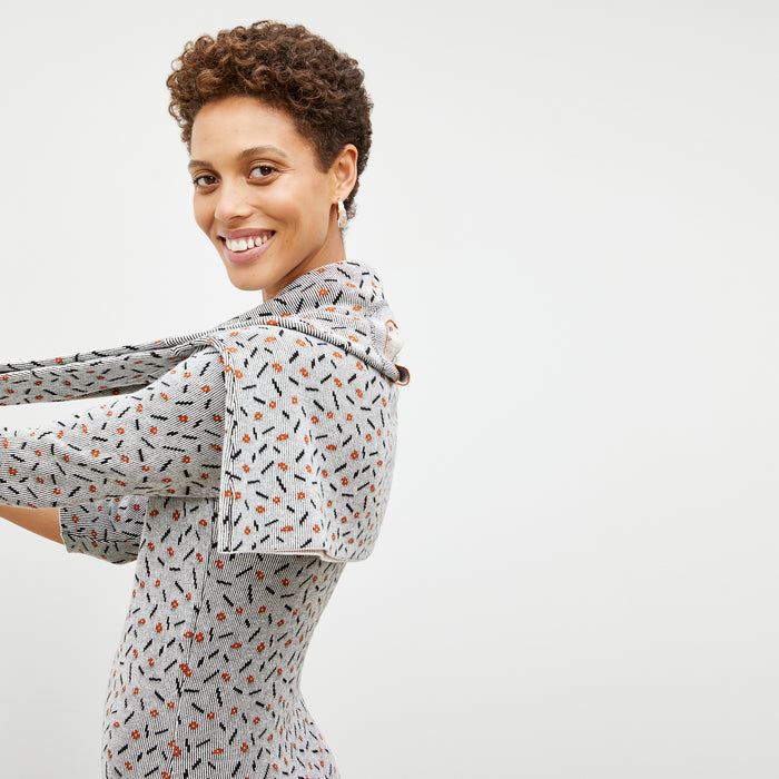 Side image of a woman wearing the Tippy Dress in Brick and Black
