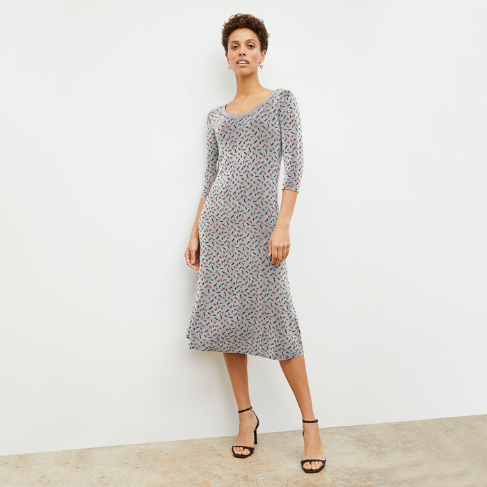Front image of a woman wearing the Tippy Dress in Brick and Black