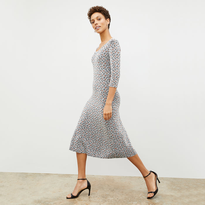 Side image of a woman wearing the Tippy Dress in Brick and Black