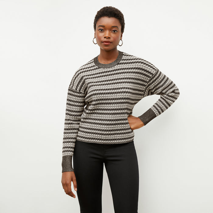 Front image of a woman wearing the tyler sweatshirt in black and white
