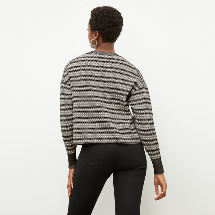 Back image of a woman wearing the tyler sweatshirt in black and white