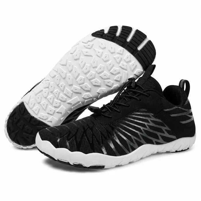 Black unisex slip-on hiking shoes with mesh uppers and segmented white outsoles, shown as a pair on a clean white background.