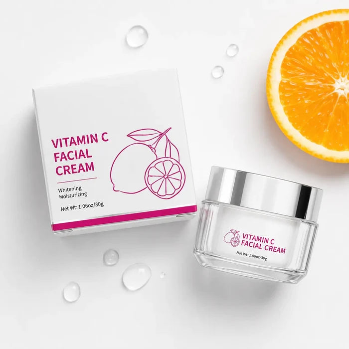 Vitamin C Facial Cream 30g flat lay with jar, carton, orange slice and water droplets on a clean white background.