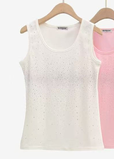White sleeveless tank top with shimmering crystal embellishments across the front for a polished boutique glam look.