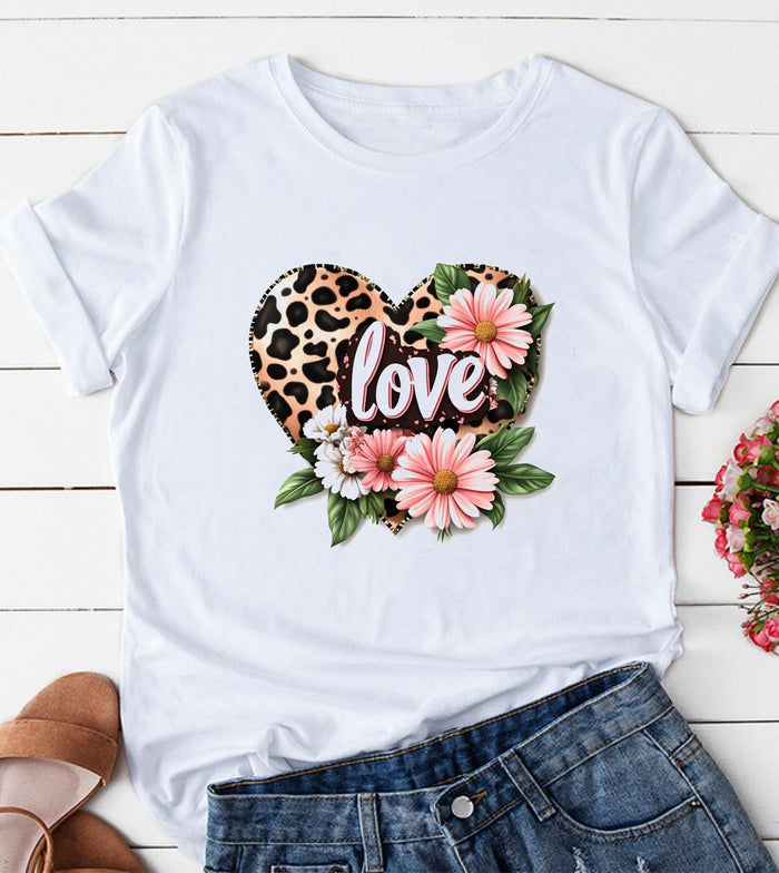 White short sleeve graphic top with a leopard print heart, pink and white floral accents, and love script on the front.