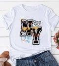 White short sleeve graphic top with bold New York NY lettering, multicolor graffiti accents, and a cartoon bear detail on the front.
