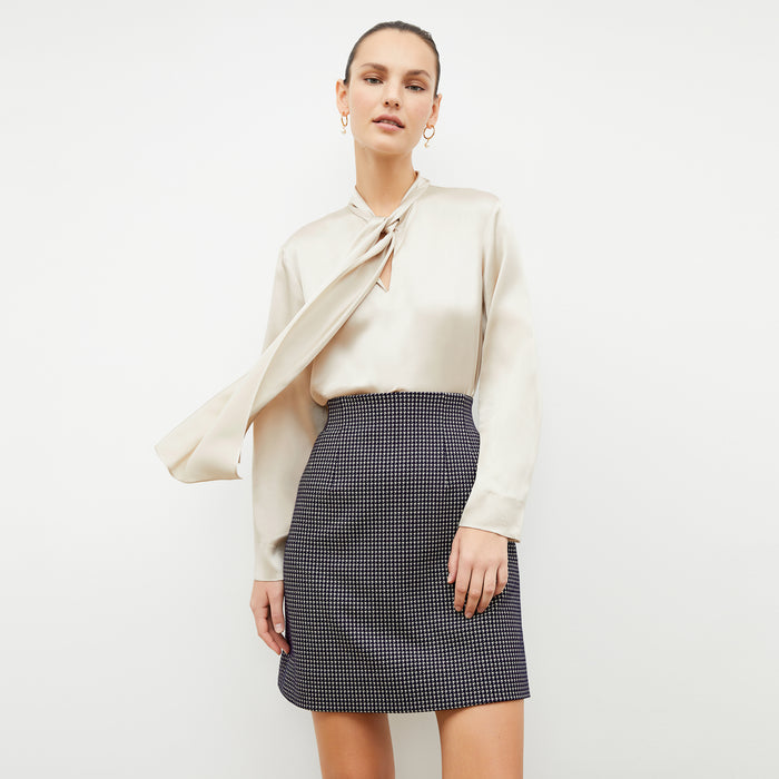 Front image of a woman wearing the whitney skirt in black and white | Lead