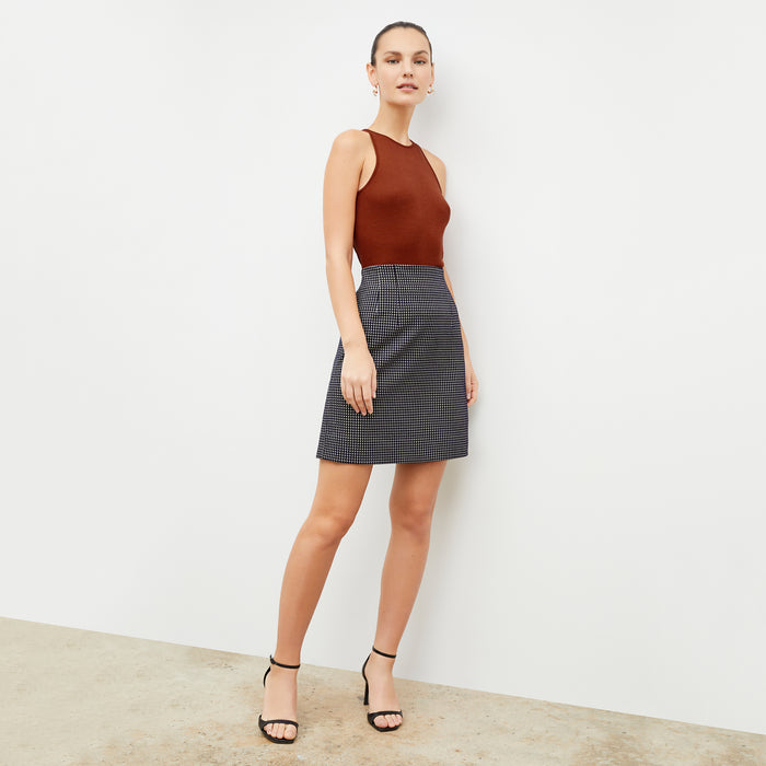 Front image of a woman wearing the whitney skirt in black and white
